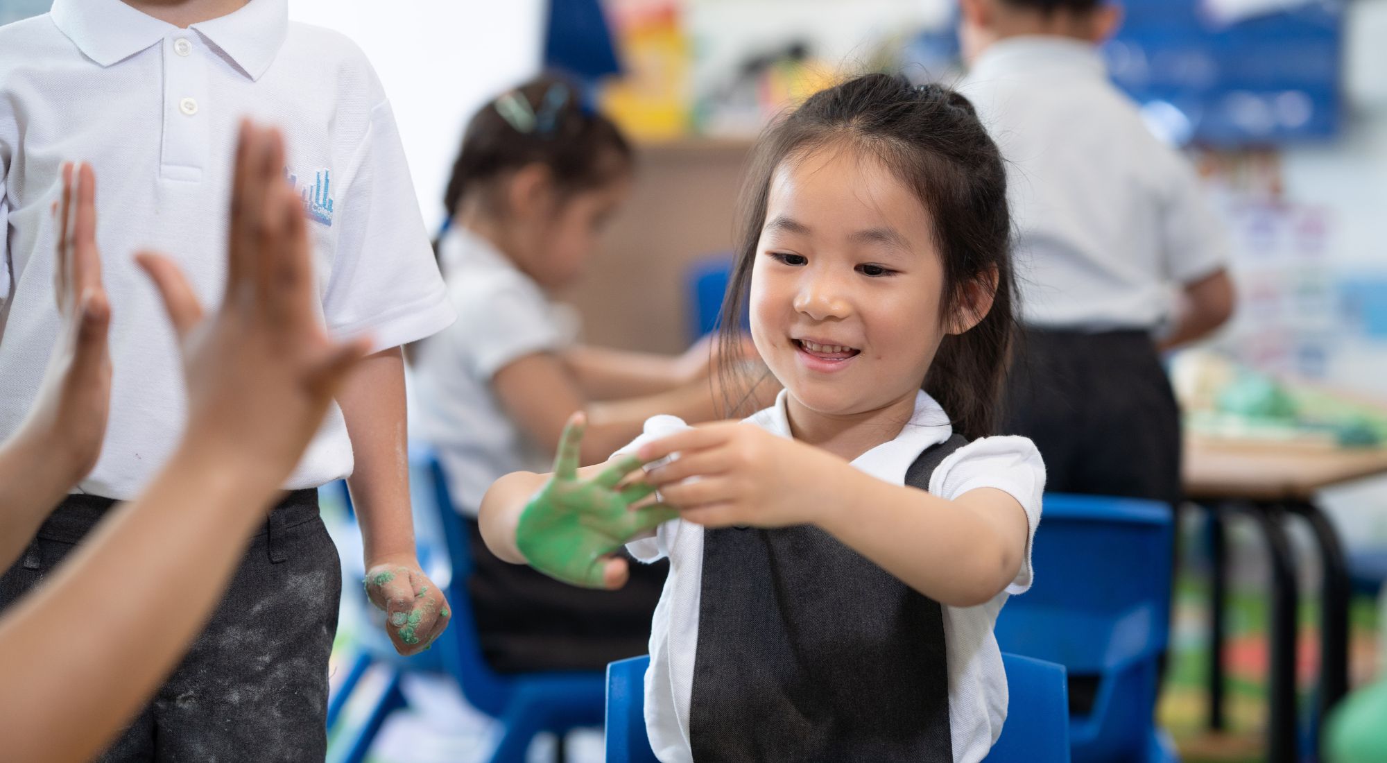 Reception pupil at Canary Wharf Primary Glenworth enjoying a creative painting activity in the classroom.